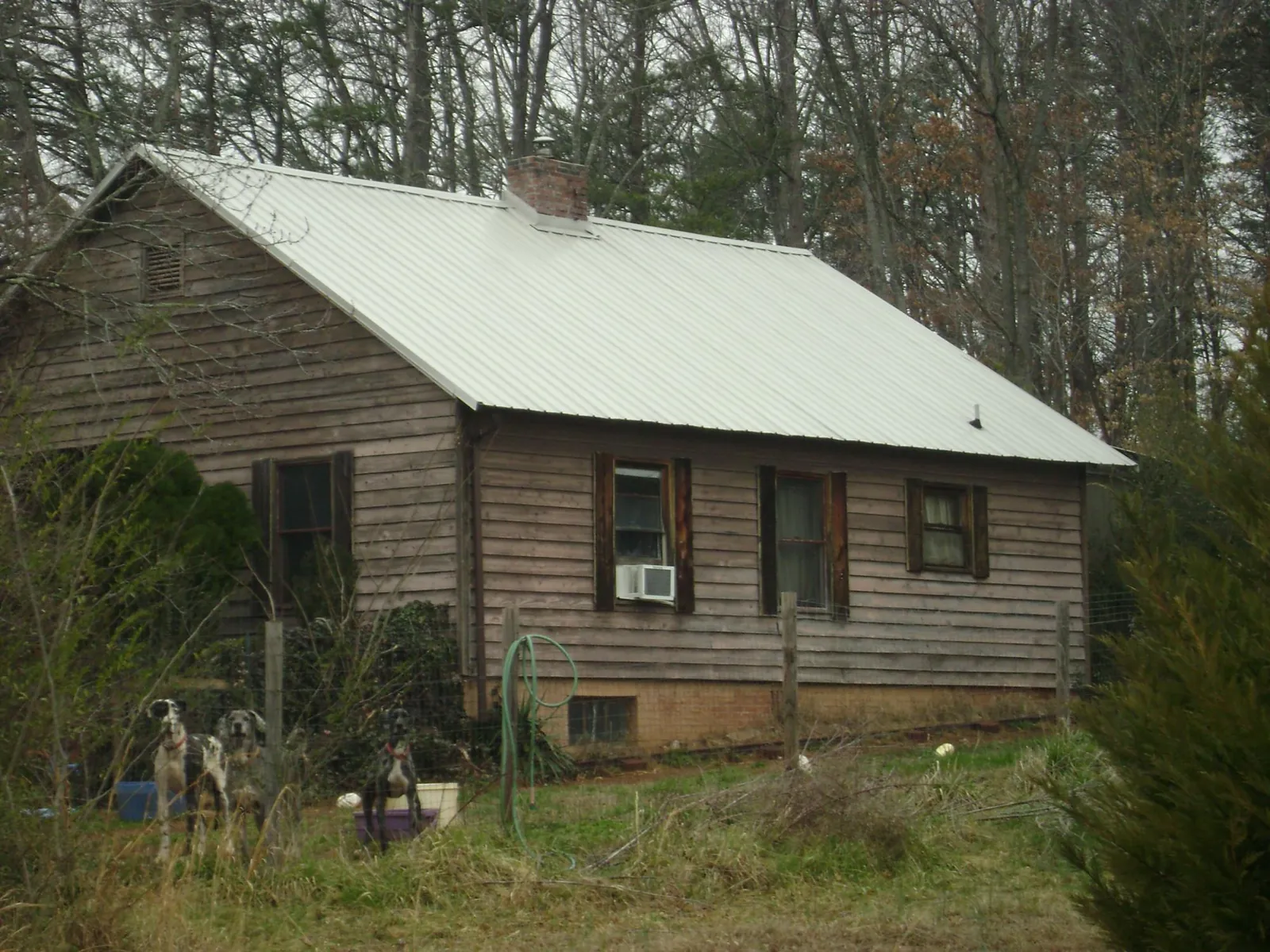 White metal roof on an old wood sided farmhouse, from a Metal Roof Installation job in Saint Joseph